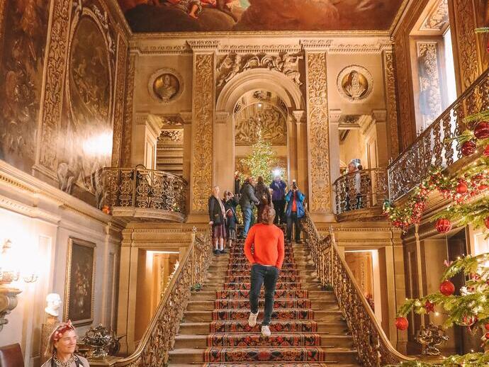 Group of people walking down stairs under a painted ceiling