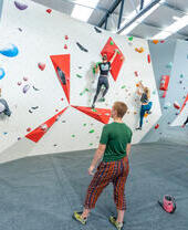 People climbing an indoor bouldering wall in Lancashire