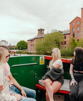 A group of people riding in a riverboat