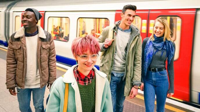 Multiracial group of hipster friends having fun in tube subway station - Urban friendship concept with young people walking together in city undergrou
