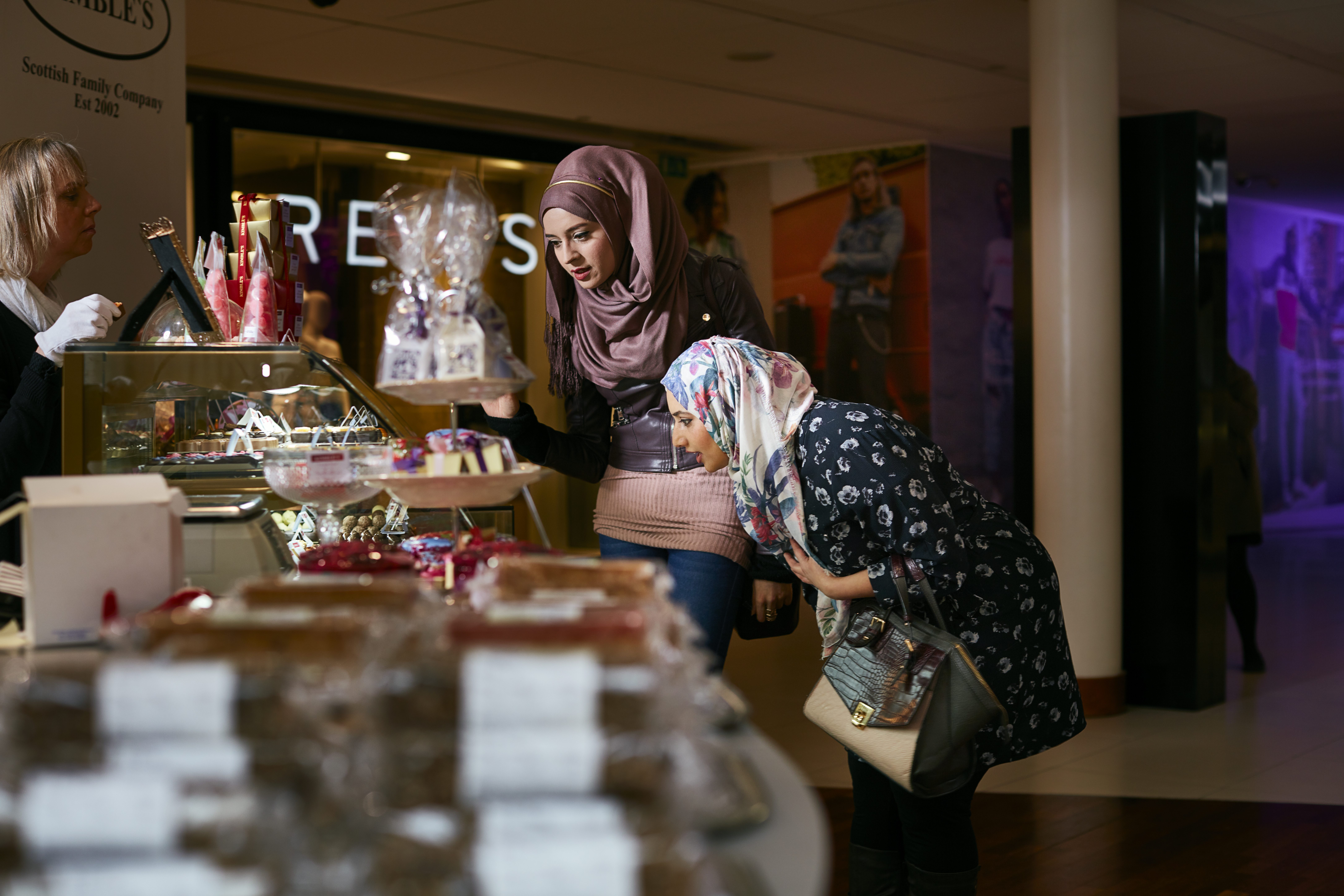 Tourists shopping in Princes Square shopping centre.