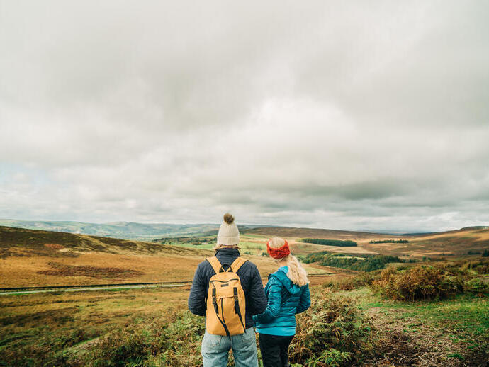 Two girls walking with panoramic views of greenery