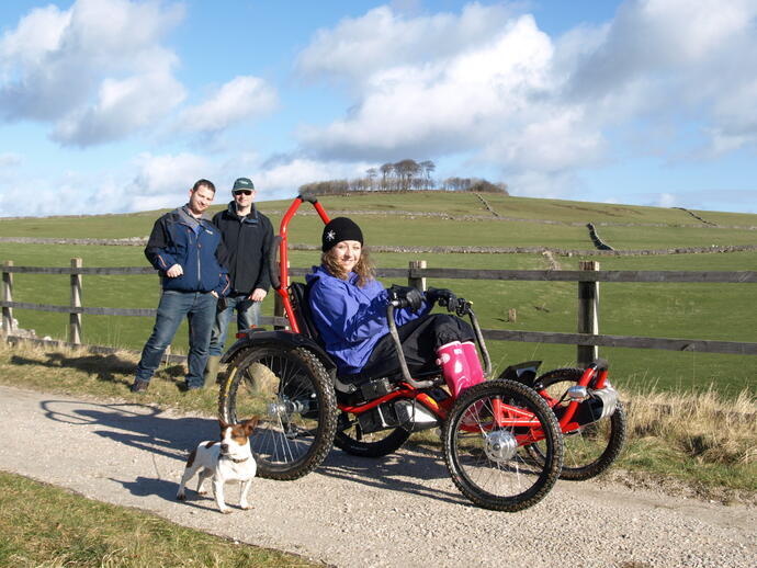 A guest using an accessible four-wheel bike at Hoe Grange Holidays, Derbyshire