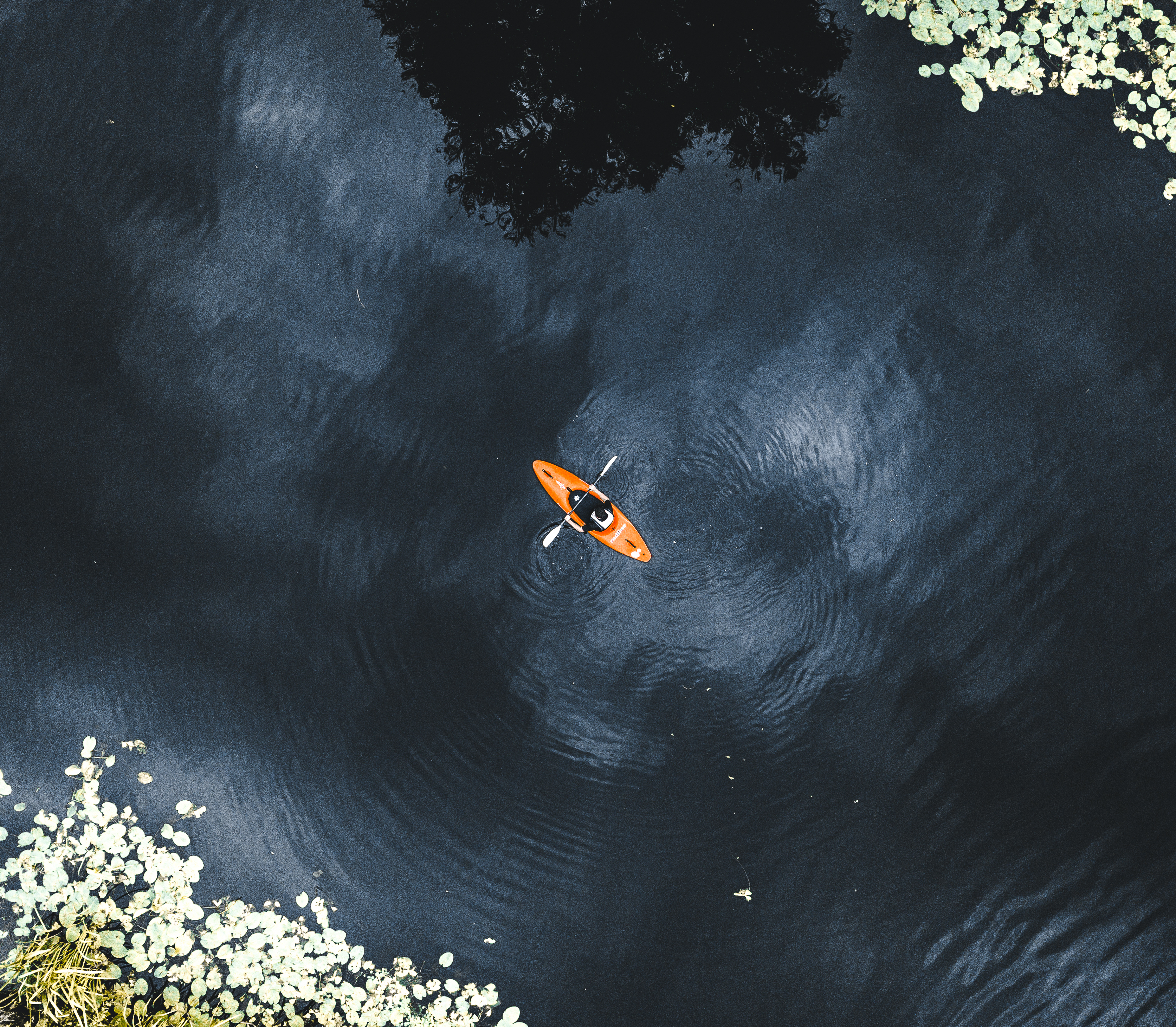 An overhead view of a person kayaking down a river in Leicestershire