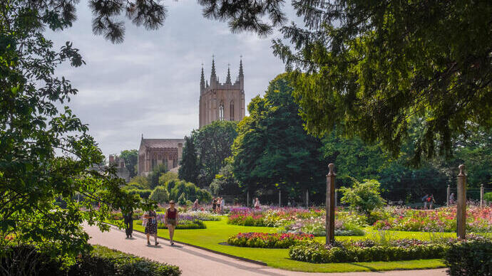 A cathedral amongst manicured gardens on a summer's day