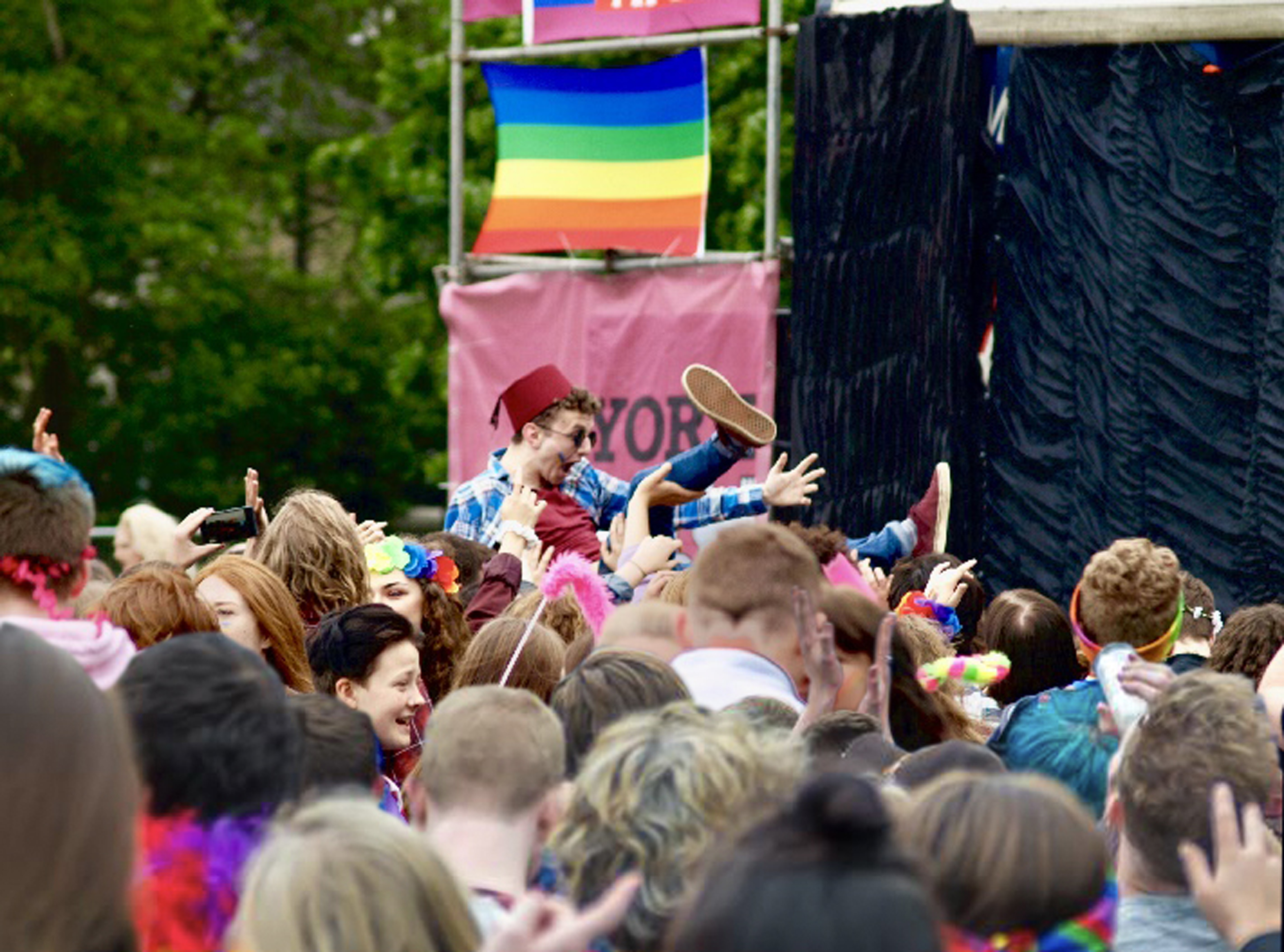A crowd watching a performance on stage at York Pride