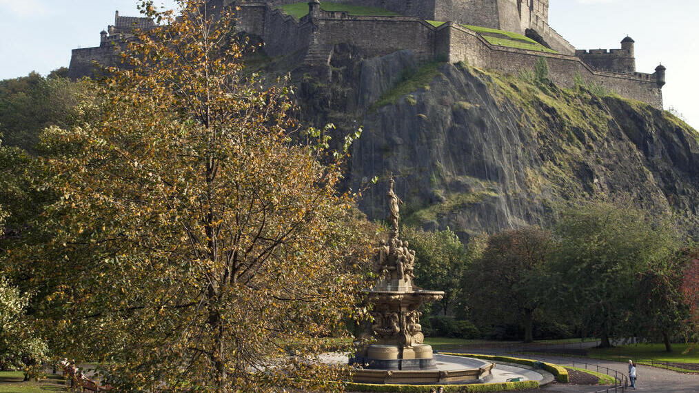 Family with children in gardens with a view up to a castle