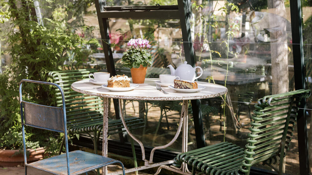 Tea and cake on a table in a garden restaurant