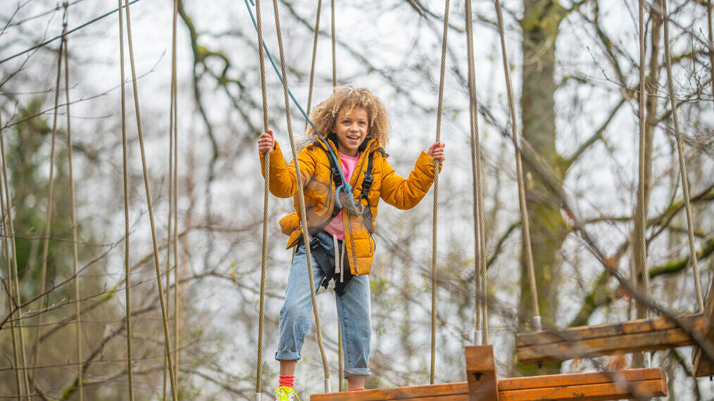 A girl on the TreeZone Aerial Adventure Course on the shores of Loch Lomond