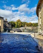 View of outdoor thermal spa with buildings in the background