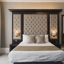 A luxury hotel bedroom with a double bed
