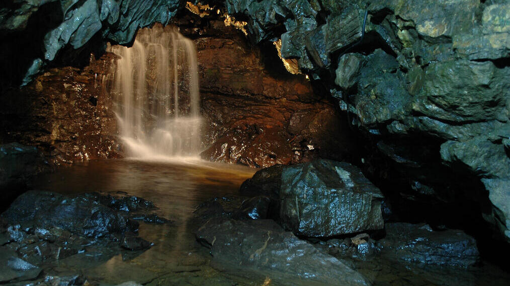 A waterfall cascade inside a cave.