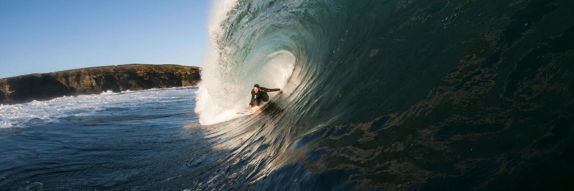 Homme surfant sur une vague géante dans la mer