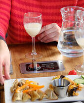 A person enjoying food and drink at a table