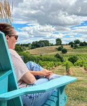 A lady sitting down at Three Choirs Vineyard