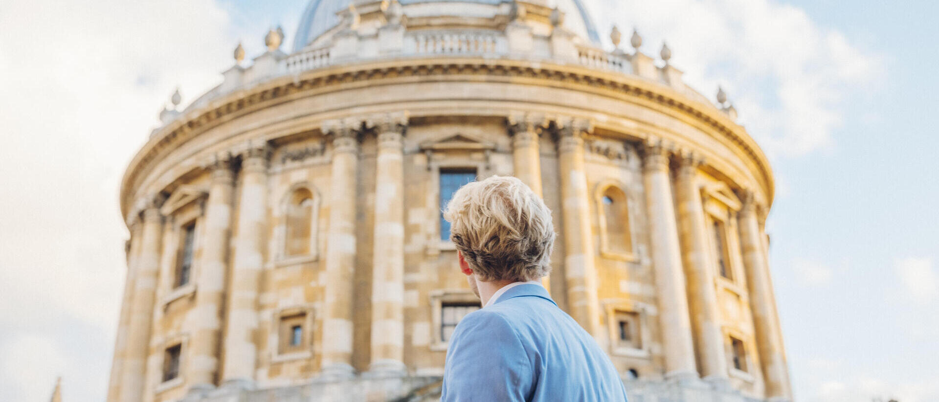 Man looking up at a historical building with dome