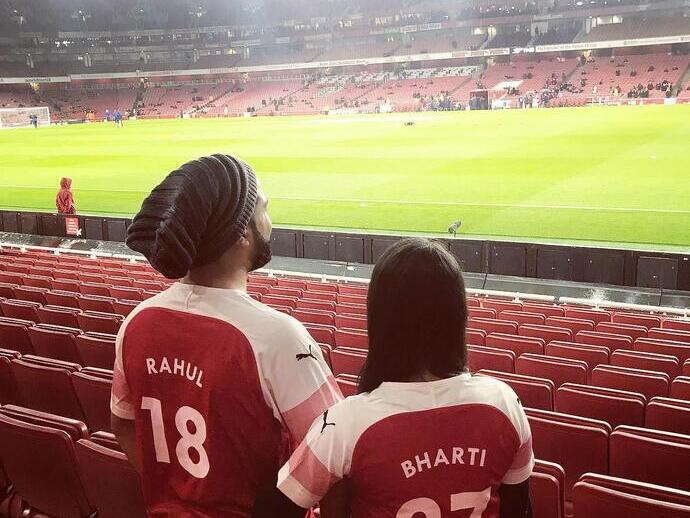 Couple stood in the Emirates Stadium during an Arsenal Stadium Tour