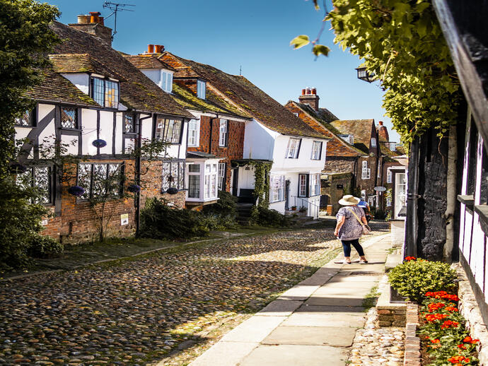 Woman looking down a narrow village street