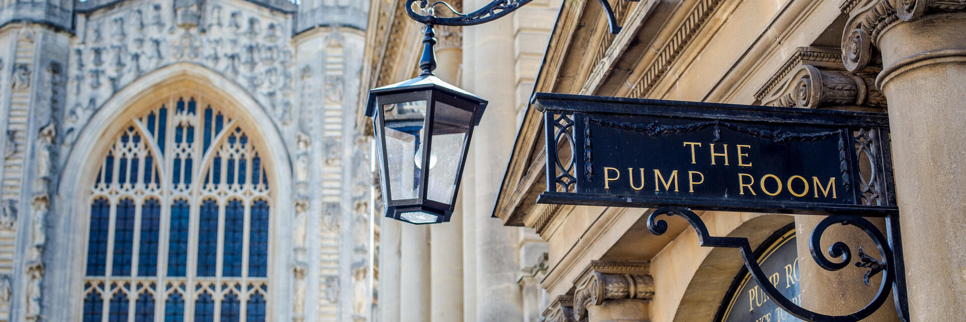 A view of the entrance to The Pump Room with a church in the background at an elegant upmarket restaurant.