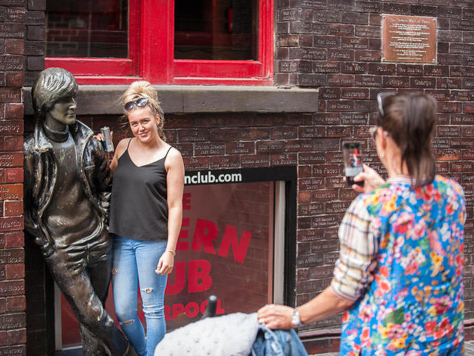 A woman posing outside the Cavern Club in Liverpool, a famous venue in the history of the Beatles
