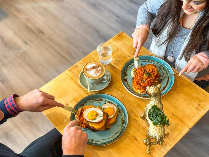 People enjoying food at a table in the Vibe Cafe in Liverpool
