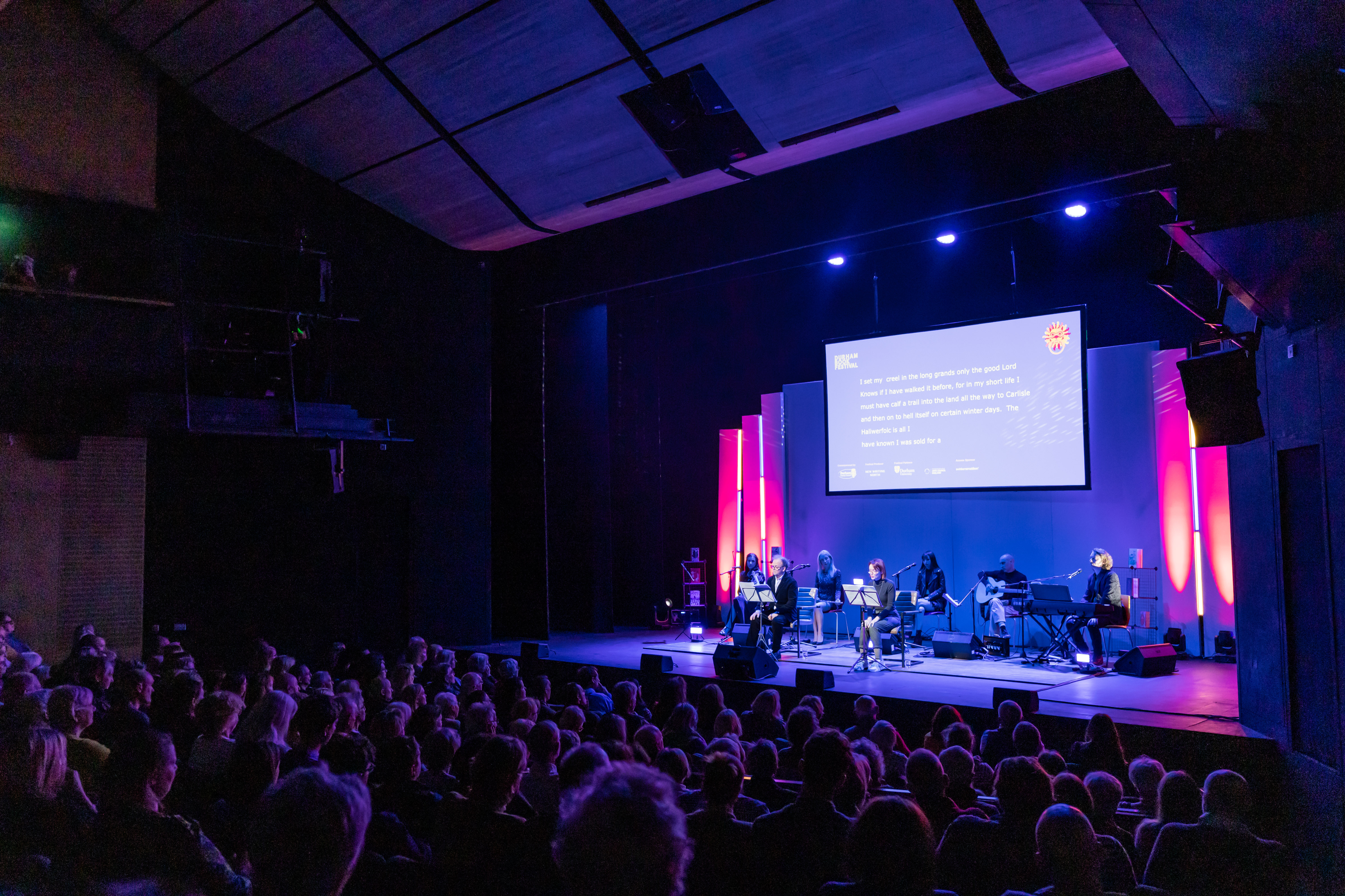 People watching a performance in a theatre
