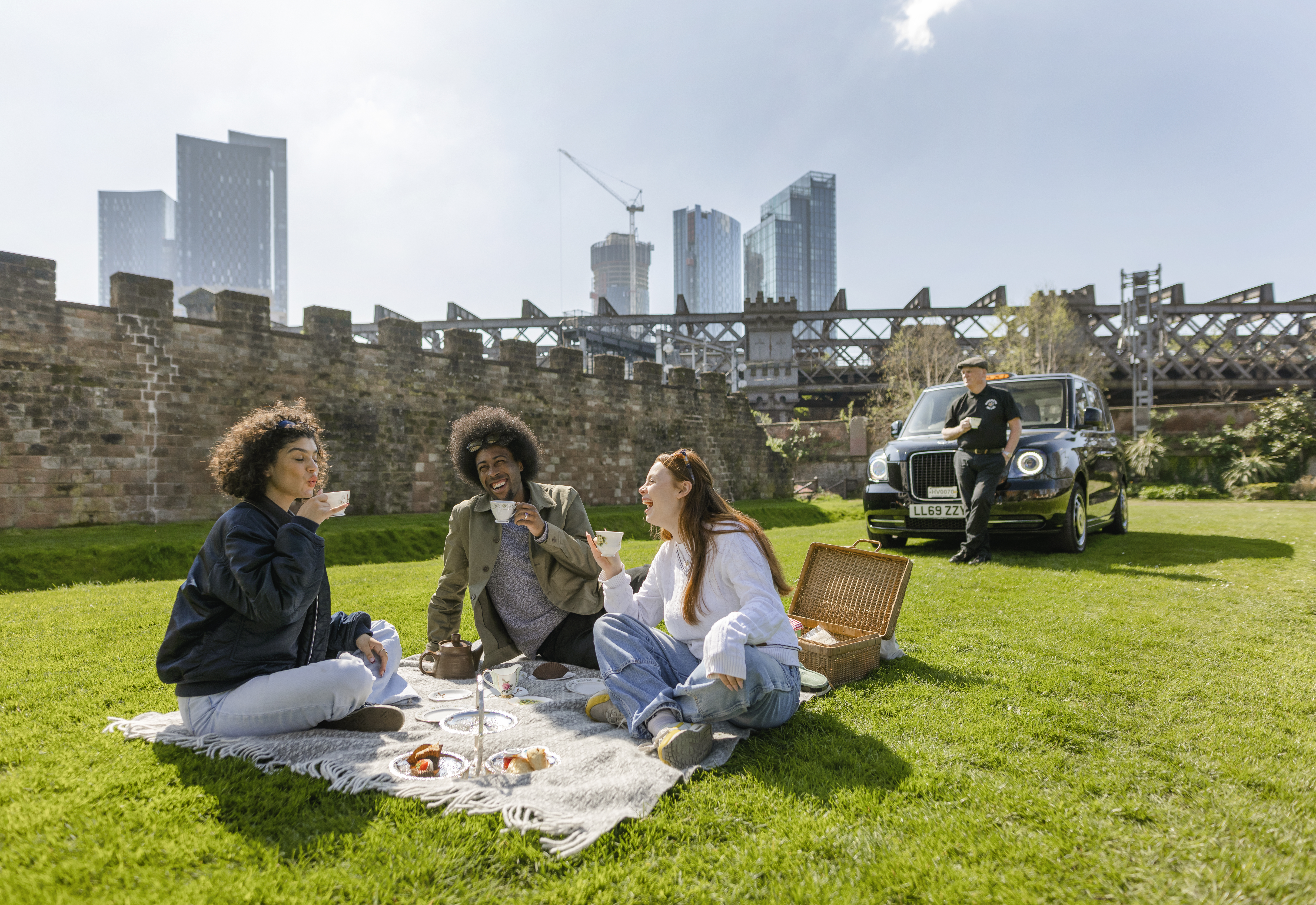 People having a picnic as part of a taxi tour in Manchester