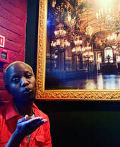 Person posing next to a framed picture at The Queen Adelaide pub