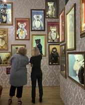 Two women looking at stuffed bears exhibits in Charlie Bears Gallery and Shop, Cornwall
