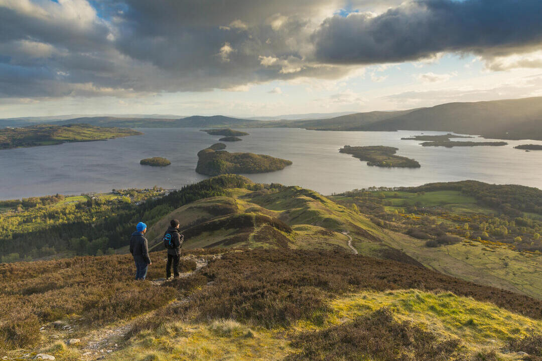 Walkers taking in the view of Loch Lomond from Conic Hill part of the West Highland Way