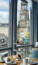 Afternoon tea setup on a table in Windows Restaurant, part of the Carlton George Hotel in Glasgow
