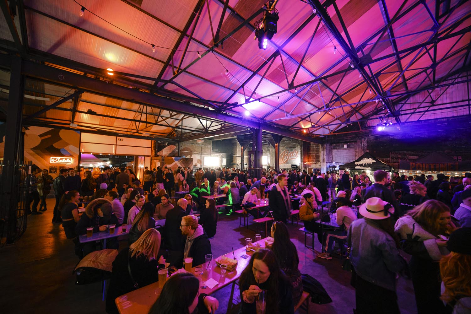 Crowds of people eating and drinking on a night out in the Peddler Market, Sheffield