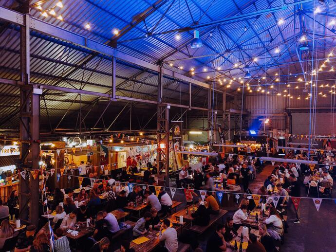 A high view of people eating a drinking at tables at Dockyard Social, Glasgow