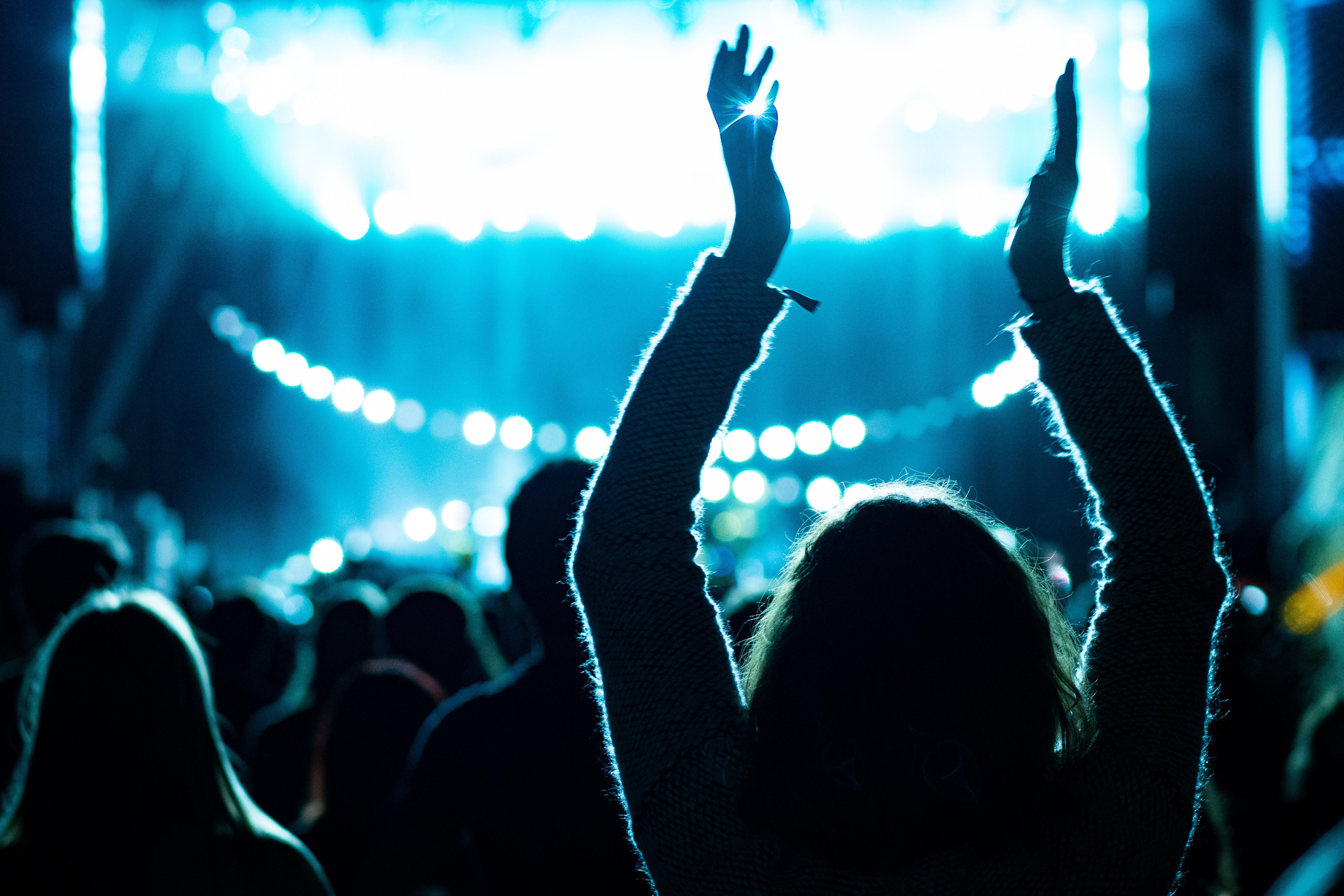 A crowd celebrating a performance at a music venue