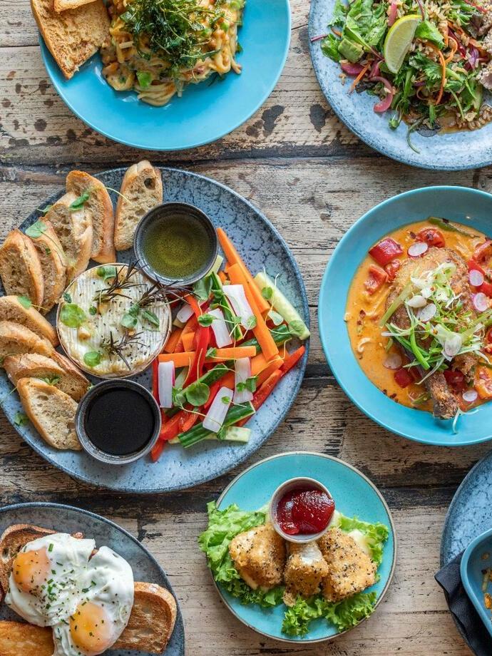 Plates of fine food presented on a restaurant dining table.