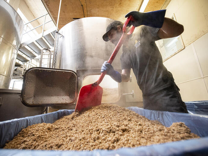 Hombre trabajando en la producción de cerveza en una fábrica