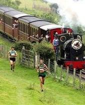 Race The Train event showing participants racing alongside a steam train in Wales