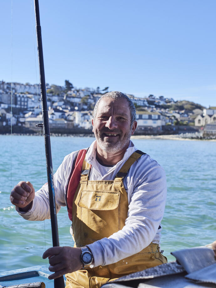 Fisherman in a fishing boat in the sea
