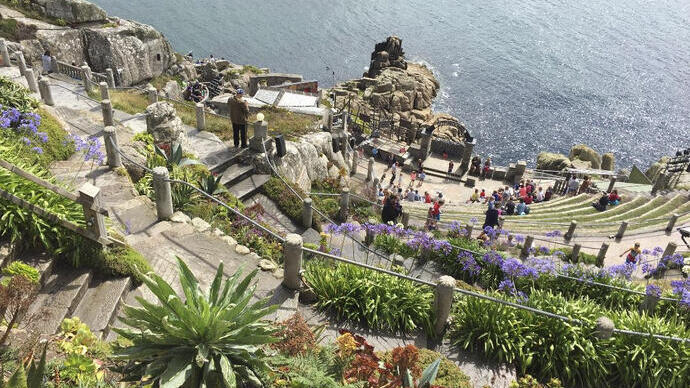 A stone theatre built into the cliff by the sea
