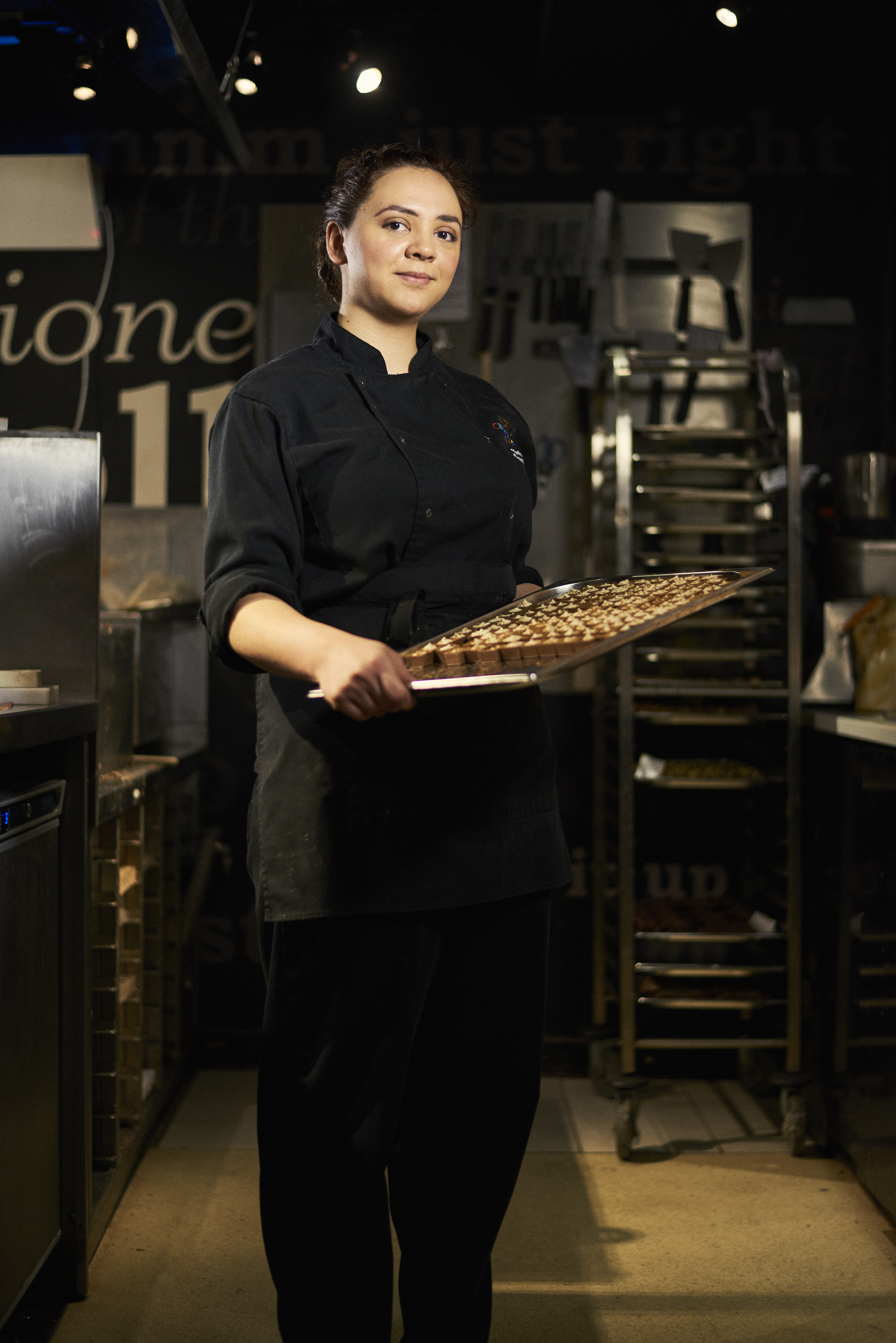 Woman presenting tray with chocolate truffles