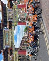 A tour group on bicycles near the Chinese Arch in Liverpool