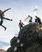 One person leaping in mid air off the cliffs.