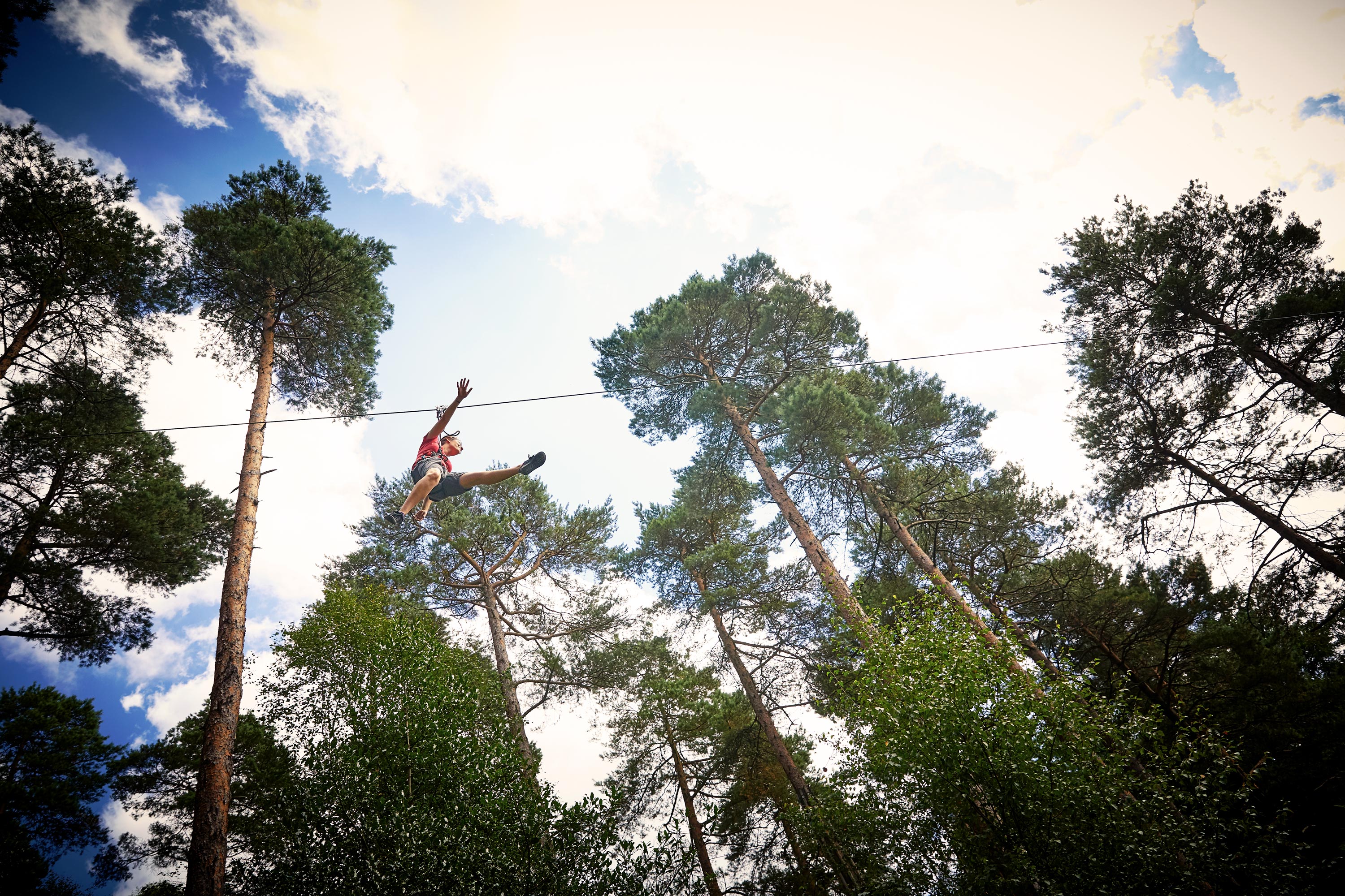An underneath shot of a person on a zipwire at Go Ape in Birmingham