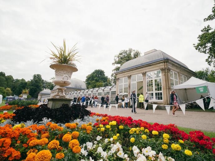 Groups of people exploring the art installations in Sheffield Botanical Gardens