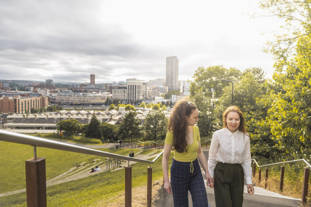 Two women in front of a city skyline