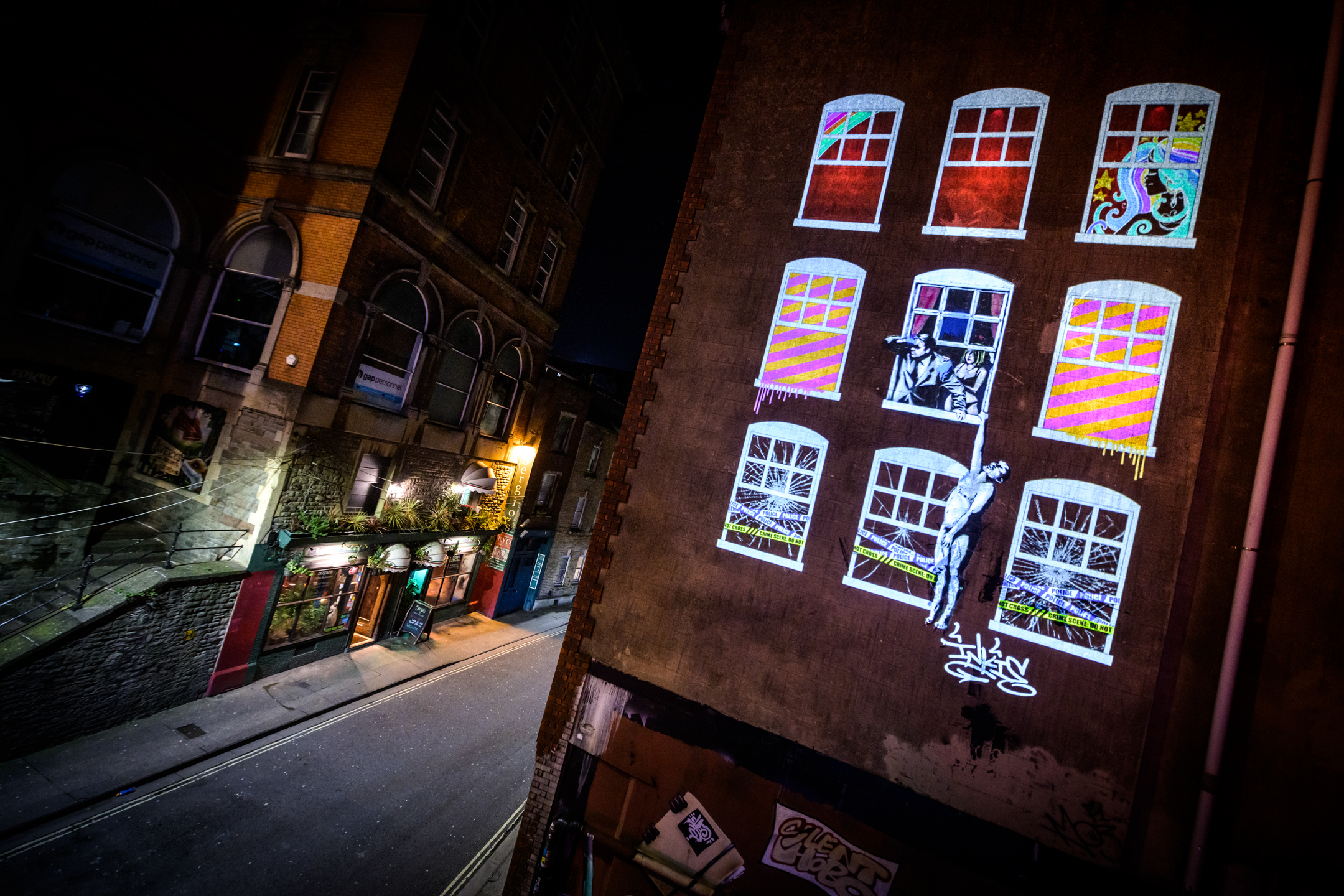 Artwork lit up on a wall in Bristol as part of Bristol Light Festival