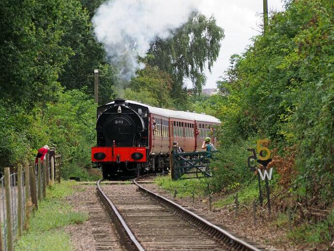 A steam train travelling through the countryside.