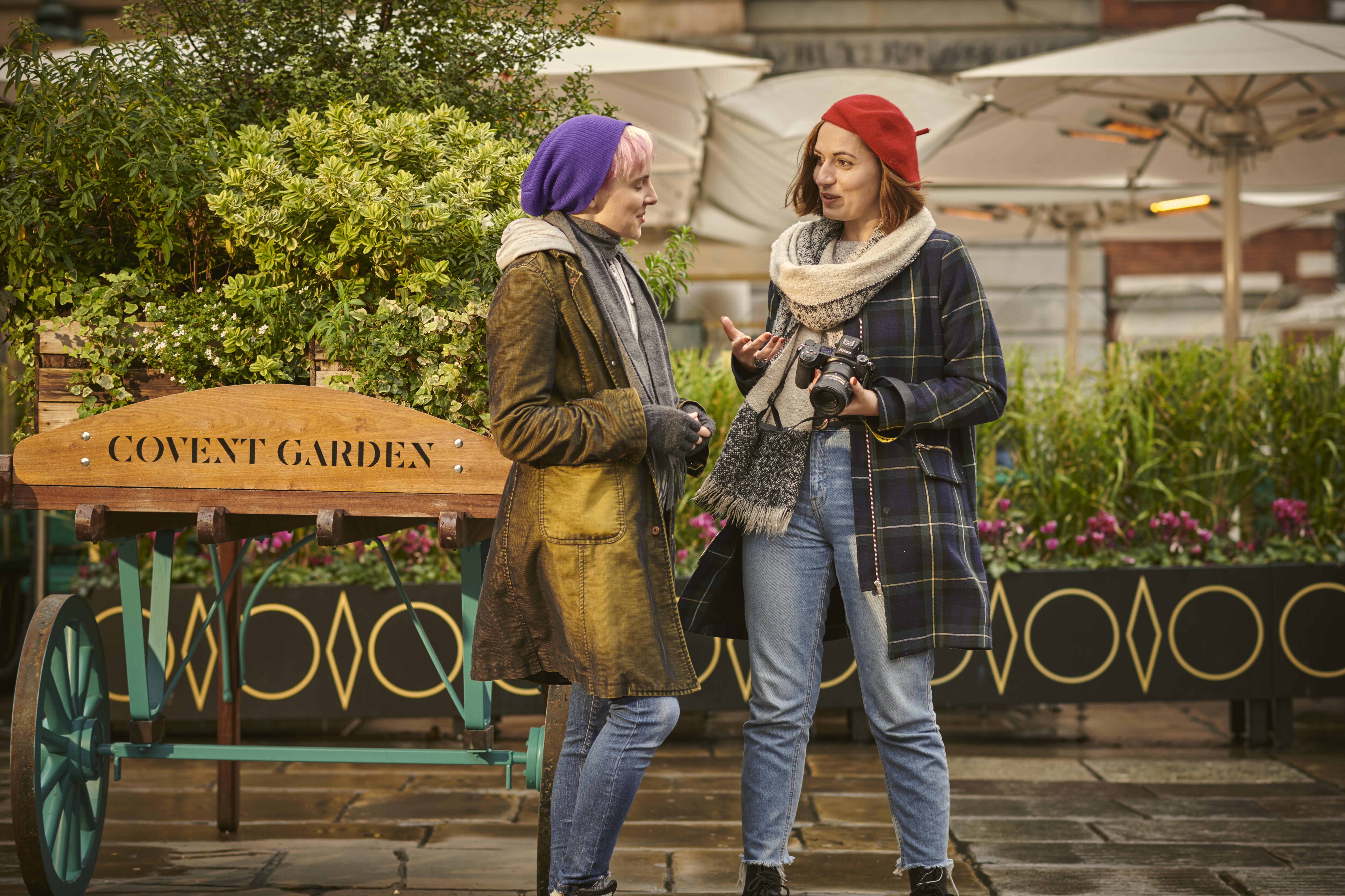 Two women talking in a piazza