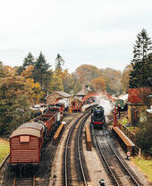 Steam train leaving a train station