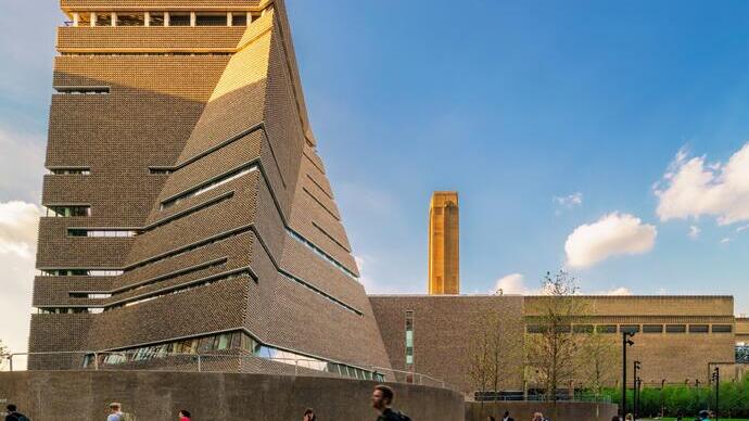 View of Tate Modern building with people walking by